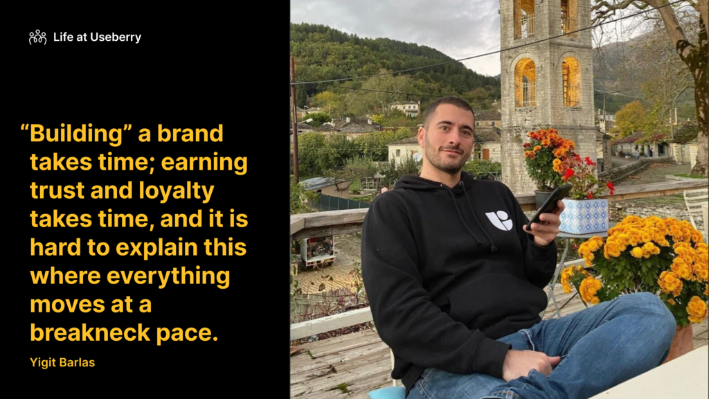 Image of our content marketer Yigit Barlas wearing a Useberry hoodie outdoors with a quote about difficulties of building a brand online. 